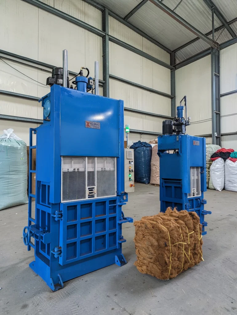 Hydraulic vertical baler for waste compression